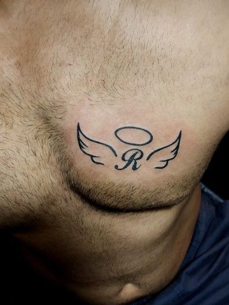 Tatuaje de alas de ángel y letra